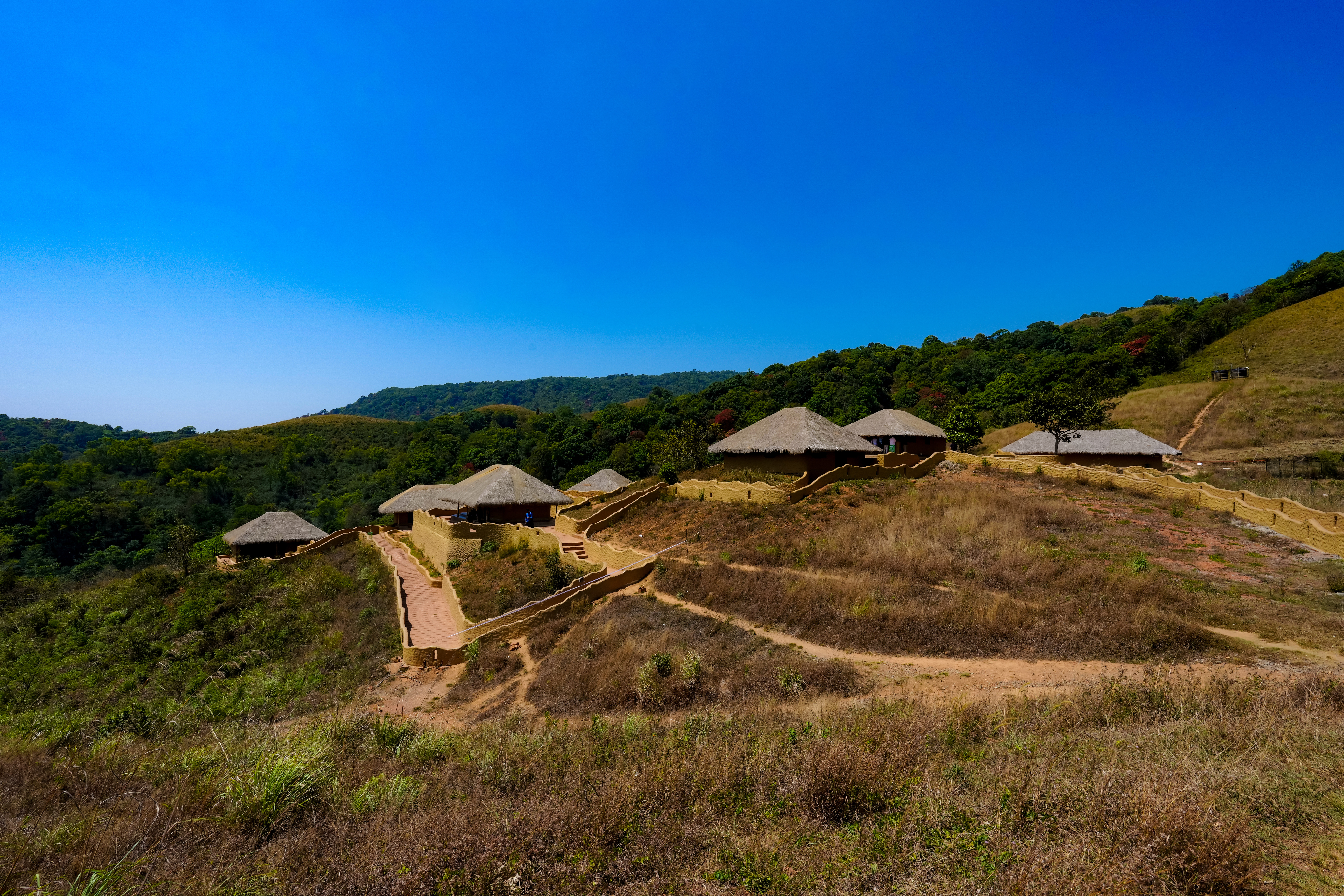 En Ooru Tribal Heritage Village at Pookode Wayanad — the Paniya community's own eco-tourism village where Karinthandan's cultural legacy is kept alive through traditional performance, crafts and community living