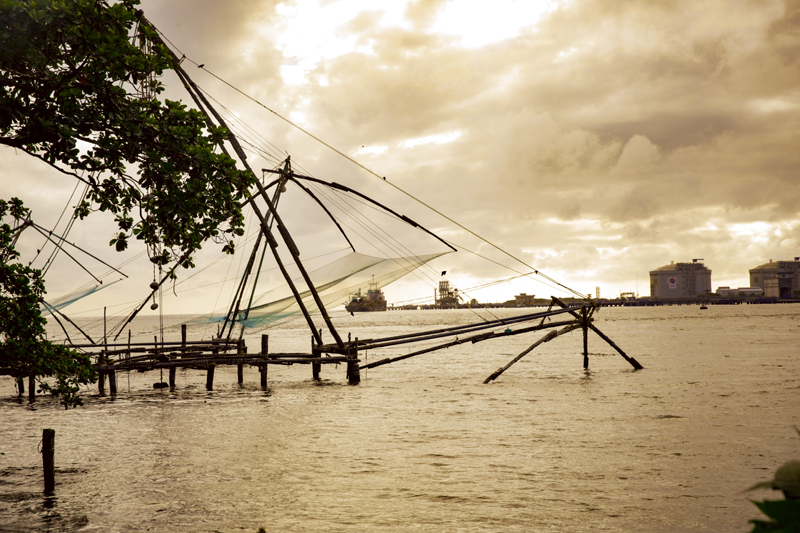 Fort Kochi waterfront with iconic Chinese fishing nets silhouetted against a Kerala sunset — five centuries of maritime heritage on one extraordinary waterfront