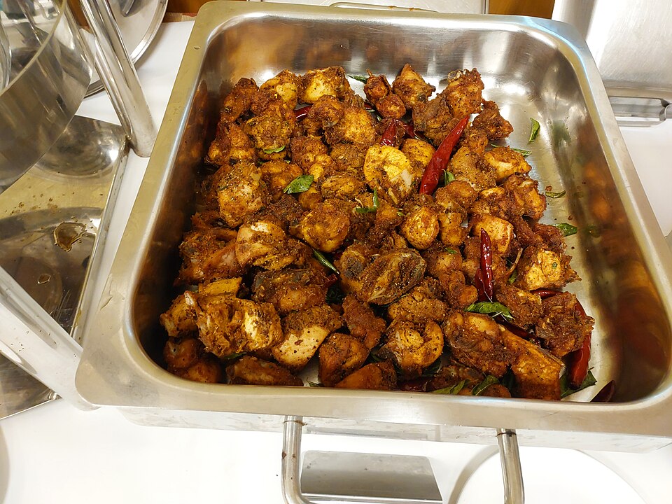 Golden-brown Malabar fried chicken pieces, showcasing the aromatic Kerala spice blend typical of regional specialties like Kozhi Thalayana.