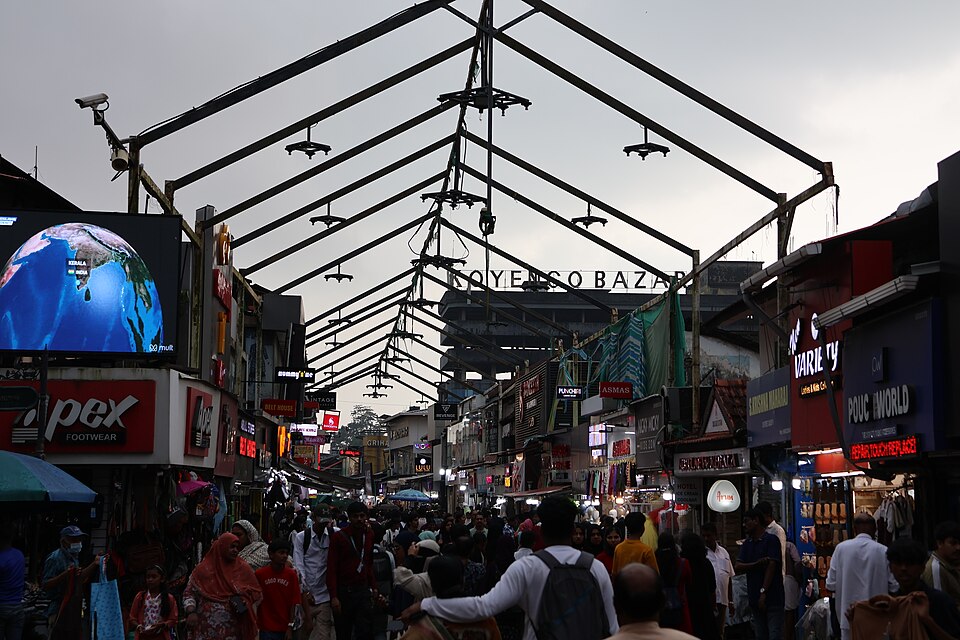 Bustling shoppers on the renovated pedestrian-only SM Street Mittayi Theruvu walkway in Kozhikode Kerala, lined with vibrant retail and textile shops.