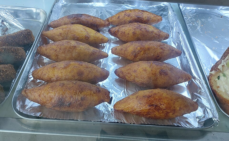 Unnakkaya: A golden-brown image of Unnakkaya, a traditional Malabar sweet snack made from mashed ripe plantains stuffed with a coconut and sugar filling.