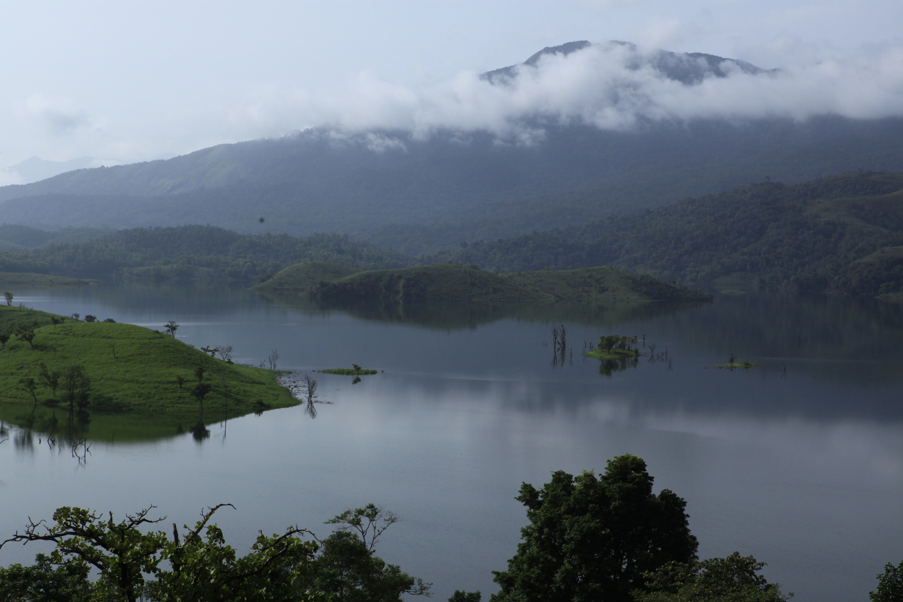 Swimming at Kanthanpara natural pool Wayanad Kerala — post-monsoon eco-tourism and nature recreation at the waterfall base